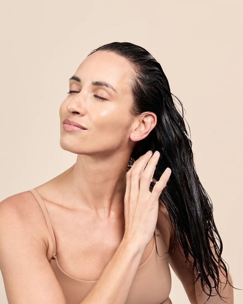 Applying the exo-grow thickening conditioner to hair and scalp after shampooing